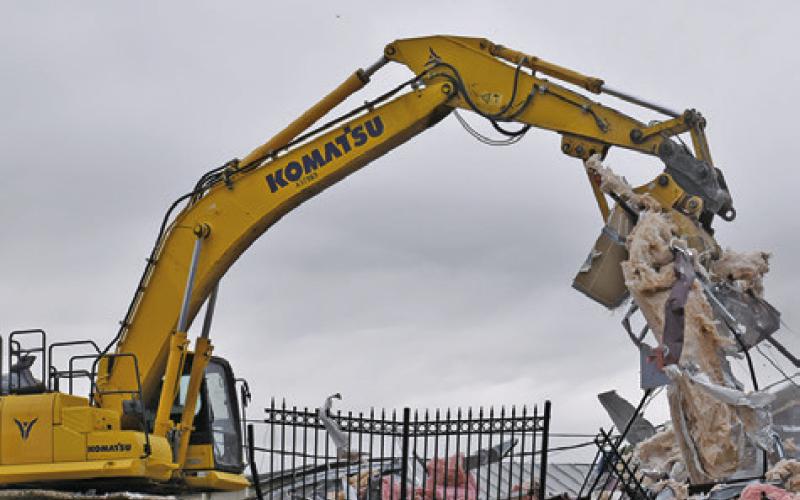 DEBRIS IS PULLED during the demolition process at the city hall construction site in downtown Caldwell. Tribune photo by Roy Sanders