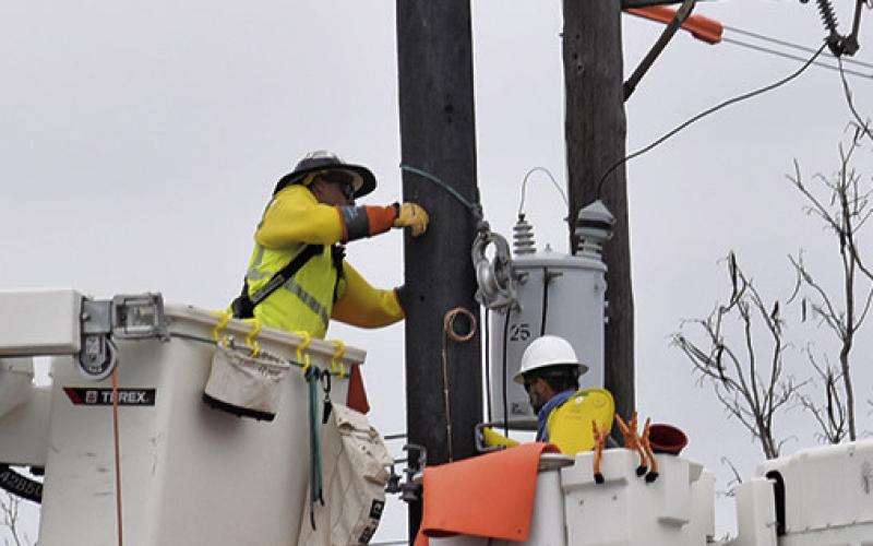 ARDENT SERVICES crew members work on electrical lines on Hill Street in Caldwell.