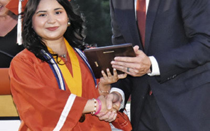 CALDWELL VALEDICTORIAN Paulina Hernandez is congratulated by Dr. James Barton, Caldwell ISD superintendent at graduation.