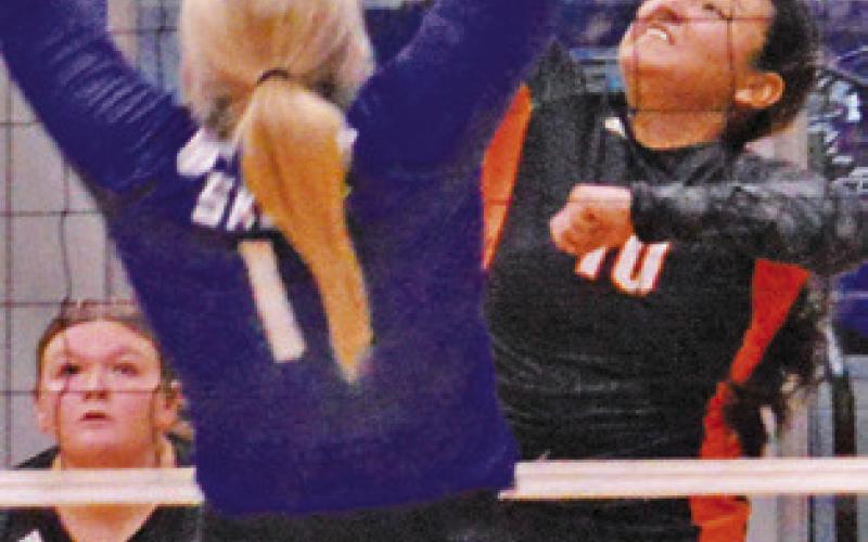 SOMERVILLE’S VIVIANNA Munoz hits the ball over Snook’s Aubrey Becker during the Snook-Somerville match last Friday.