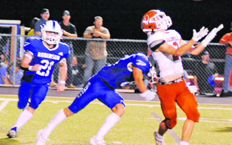 CALDWELL RECEIVER CONOR Lee goes for the ball last Friday against Robinson. -- Tribune photo by Denise Squier
