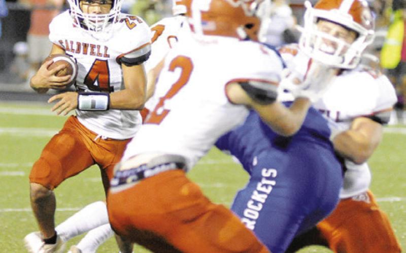 CALDWELL RUNNING BACK Aidan Torres carries the ball against Robinson last Friday. -- Tribune photo by Denise Squier