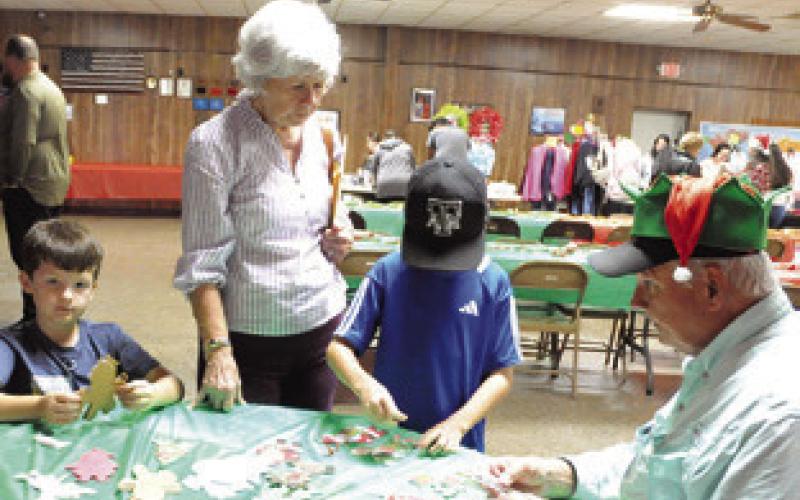 CHILDREN AND CHILDREN AT heart played games and worked with crafts and puzzles at Saturday’s “Breakfast with the Claus’ ” held at the VFW Post in Caldwell.