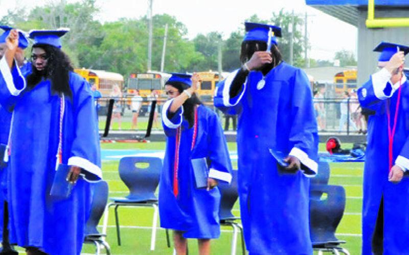SNOOK HIGH SCHOOL GRADUATES move their tassels during Friday night’s graduation ceremony. -- Tribune photo by Denise Squier