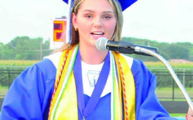 SNOOK VALEDICTORIAN Alexis Macik addresses her classmates during Friday night’s high school graduation at Bluejay Stadium.
