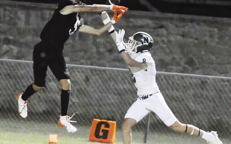 SOMERVILLE’S KYLE BROOKS reaches for this pass as this Normangee player defends. The Yeguas won 21-0 in their opener. Tribune photo by Denise Squier