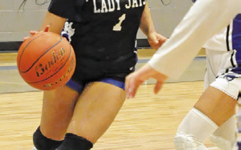 ALANA STRINGFELLOW drives the ball toward the basket during the Snook-Mumford game last Friday night in Mumford. Tribune photo by Denise Squier