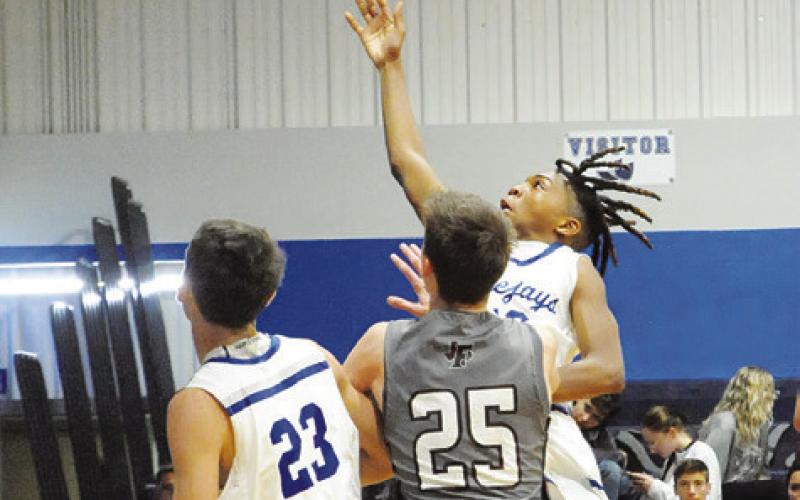 SNOOK’S JOHN CARR shoots against Fayetteville in last Tuesday’s game in Snook. -- Tribune photo by Denise Squier