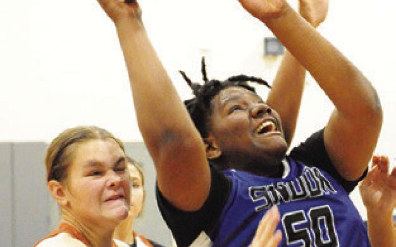MYKIA MUNSON puts up a shot against Caldwell on Saturday at the Lady Hornet Classic. -- Tribune photo by Denise Squier