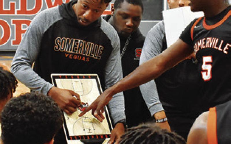 TERRANCE PRESTON, Somerville’s new head basketball coach, talks to his players during a timeout in the Caldwell game.