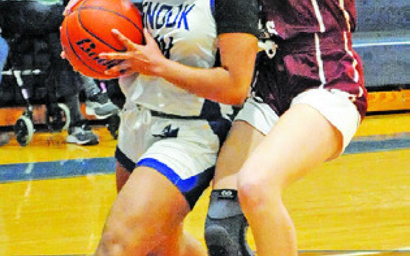 ALANA STRINGFELLOW is fouled while driving to the basket during the Snook-Fayetteville game last week. -- Tribune photo by Denise Squier