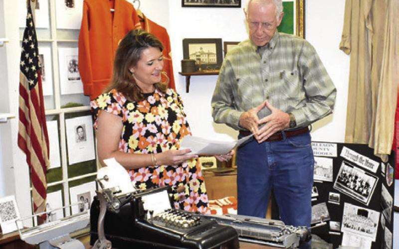 AMY JURICA AND Steve Tunnell look over these items at the Burleson County Historical Museum at the county courthouse.