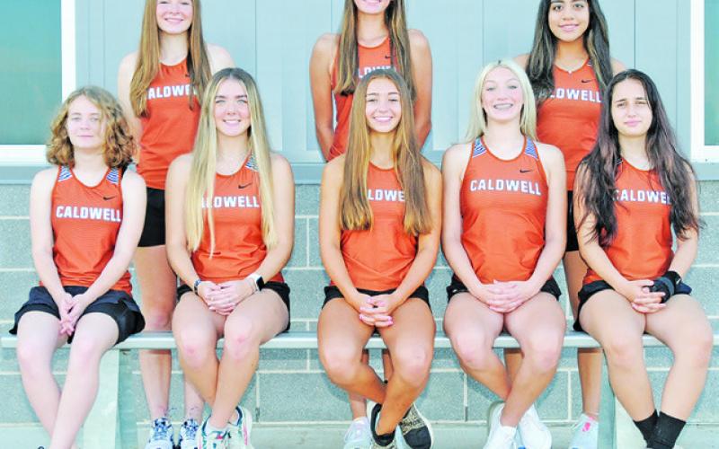 THE 2022 CALDWELL LADY HORNET CROSS country team is, from left, sitting, Fallyn Anderson, Hannah Muzny, Natalie Eastepp, Kori Archer, Ella Bares, standing, Cadie Coston, Kysen Toney and Isabel Alcocer. Not pictured are Gezlynn Wolfe, Adeline Hicks and Kaylan Groce. -- Photo courtesy of Dianne Pursch Photography