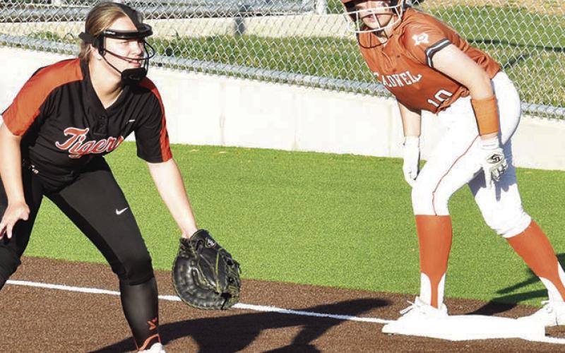 CALDWELL’S KELLY URBANOVSKY watches the Smithville pitcher while she’s at first base during the Caldwell-Smithville game last Friday night.
