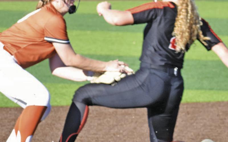 A SMITHVILLE PLAYER TRIES to avoid the tag from a Caldwell infielder during the Caldwell-Smithville game last Friday night.
