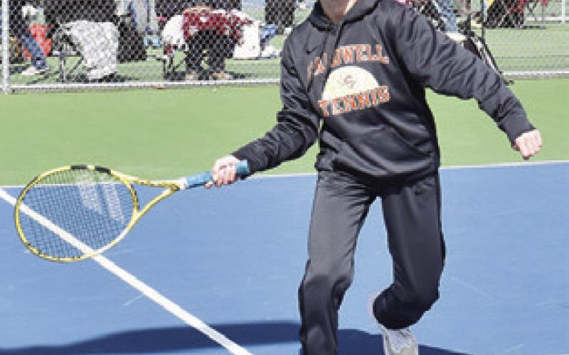 TILLY HICKS PREPARES to return the ball during a girls’ doubles match at the Caldwell Tennis Tournament. -- Tribune photo by Roy Sanders