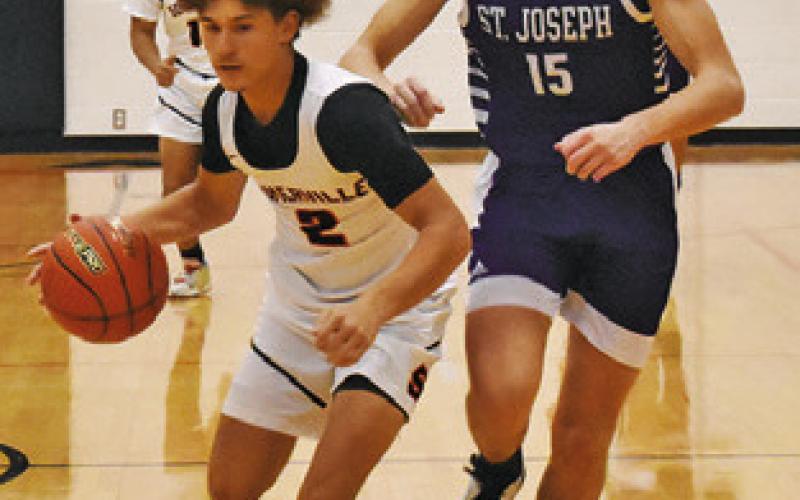 SOMERVILLE’S JAYDEN Young dribbles the ball past this St. Joseph defender. Tribune photo by Roy Sanders
