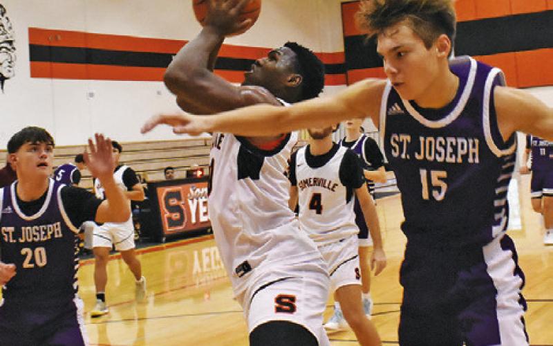 JA’KEITH DANIELS TAKES lunges for this shot against St. Joseph. Tribune photo by Roy Sanders