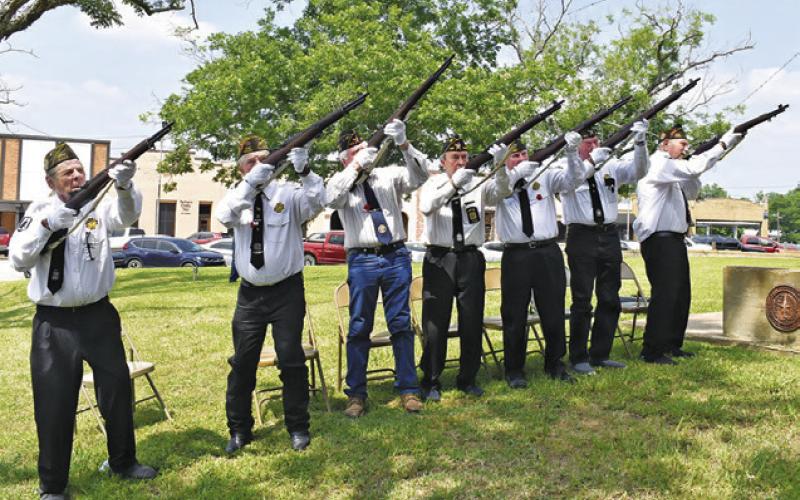 THE CALDWELL VFW RIFLE Honor Guard fires its salute on Monday during the Memorial Day ceremony at the Burleson County War Memorial. -- Tribune photo by Roy Sanders