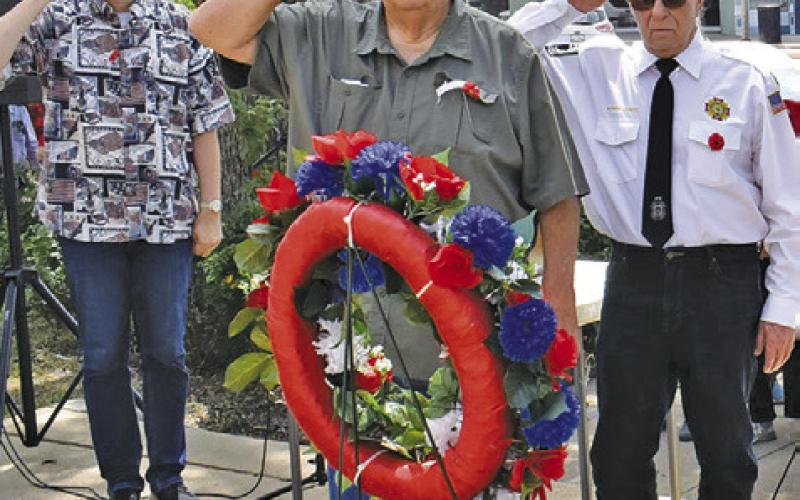 TONY ZACCAGNINO, Donny Wood and Henry Probst salute during the laying of the wreath at the Memorial Day service. Also participating was John Mayson. -- Tribune photo by Roy Sanders