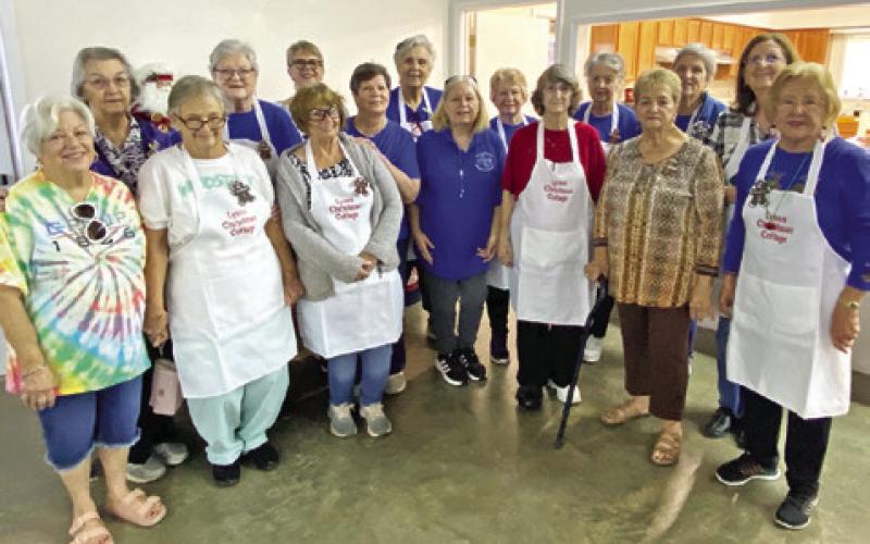 VOLUNTEERS FOR THE Christmas Cottage event pose for a group photo. This annual event was hosted by the Lyons Education Extension Association on Nov. 7 and 8. Complimentary gingerbread cookies and wassail were available for attendees. Photo courtesy of Lyons EEA