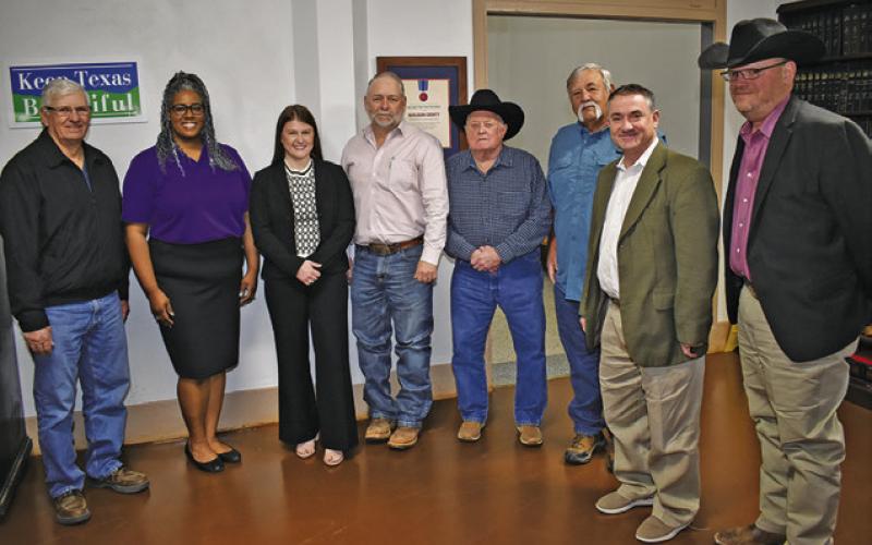 BURLESON COUNTY COMMISSIONERS are joined by Ashley James and Briana Mackey, second and third from the left, and by Eric Zimmerman and John Grange, far right. The commissioners include Vincent Svec, Burleson County Judge Keith Schroeder, and Commissioners David Hildebrand and Bobby Urbanosky.
