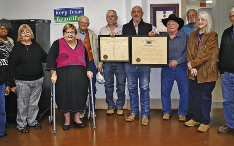 BURLESON COUNTY COMMISSIONERS are joined by the Burleson County Historical Commission in displaying these certificates donated for the old post office in Cooks Point. Pictured from left are Mahalia Nix, Diann Scott, Gayla Townsend, Melynda Giesenschlag, Tommy Ryan, Burleson County Judge Keith Schroeder, Emergency Management Coordinator Jody Tillery, Commissioner David Hildebrand, Commissioner Bobby Urbanosky, Tammy Kubecka and Commissioner Vincent Svec.