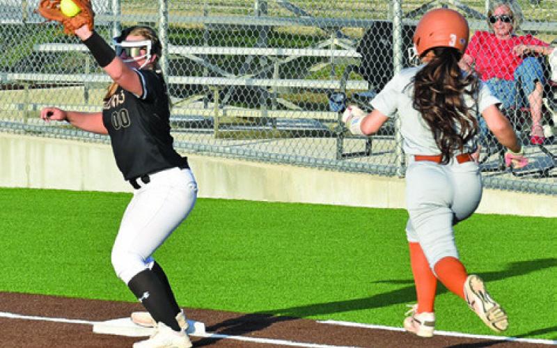 JAELYNN GEST TRIES TO outrun the throw to first during the Caldwell-Giddings game last Friday night at Weiss Field. Tribune photo by Roy Sanders
