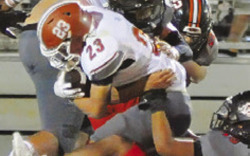 BRAXTON FRITCHER FIGHTS through this Gonzales defender for extra yardage. -- Tribune photo by Denise Squier