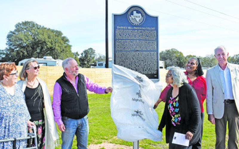 A HISTORICAL MARKER is unveiled on Sunday, Feb. 12, for the Dabney Hill Freedom Colony. Burleson County Judge Keith Schroeder and Gloria Smith conduct the unveiling. Also pictured are Melynda Giesenschlag, Peggy Gaskamp Sanders, Sharon Prejean and Steve Tunnell. -- Tribune photo by Roy Sanders