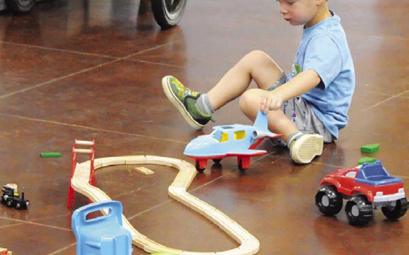 THE YOUNGER CHILDREN attending last Thursday morning’s “Spark” event held by the Harrie P. Woodson Memorial Library were able to build roads and bridges and play with transportation toys. Tribune photo by Denise Squier