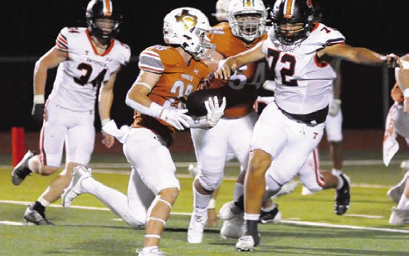 BRAXTON FRITCHER OF Caldwell carries the ball as Luke Novosad blocks in the Hornets’ 49-24 win over Smithville. Tribune photo by Denise Squier
