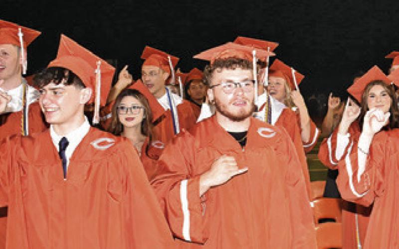 CALDWELL HIGH SCHOOL graduates sing the school song for the final time during the Friday commencement ceremony.