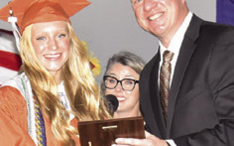 DR. JAMES BARTON, Caldwell superintendent, recognizes Caitlyn Faust as Caldwell High School’s Third Honor Graduate.
