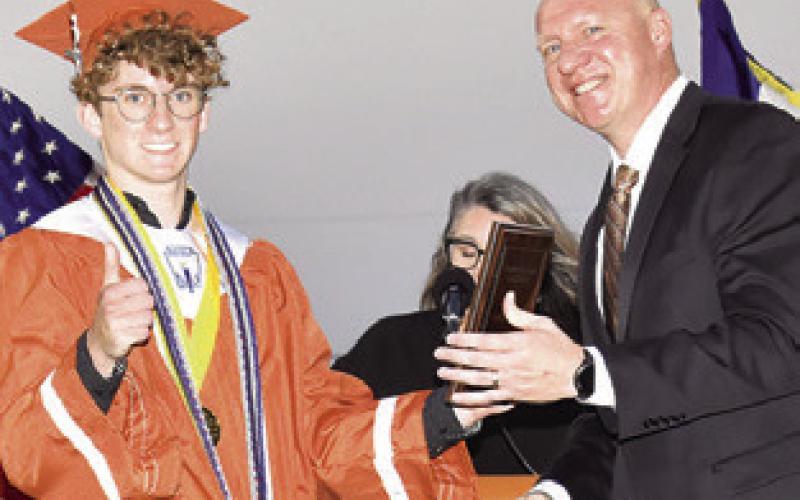 KAYDEN ROSKEY is recognized by Dr. James Barton, Caldwell superintendent, as Caldwell High School Salutatorian.