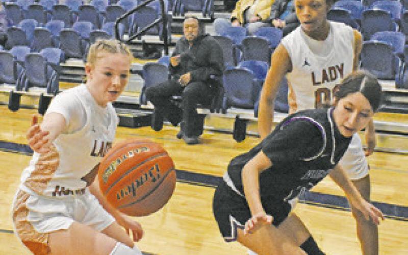 CALDWELL’S CADIE COSTON tries to keep the ball in bounds during the Lady Hornets’ win over Austin Achieve last Friday night at Hornet Gym.