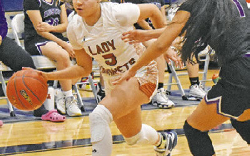 ASHLYN KELLUM DRIBBLES down the court while an Austin Achieve player defends.