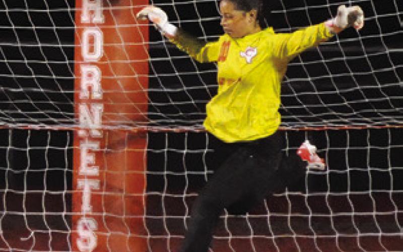 LADY HORNET GOALIE Mercy Chollett sets to kick the ball away from the goal during Caldwell’s game against Florence on Friday. Tribune photo by Denise Squier