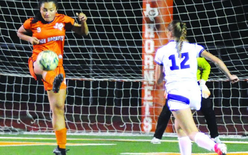 CALDWELL LADY HORNET Angie Lobo kicks the ball away from the Caldwell goal during Caldwell-Florence game on Friday. Tribune photo by Denise Squier