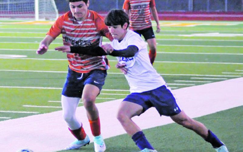 HORNET SOCCER PLAYER Luis Orostieta and a Florence player fight for possession of the ball while Reymon Leyva looks on during the Caldwell-Florence game on Friday night at Hornet Field. Tribune photo by Denise Squier
