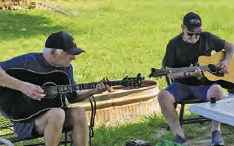AREA MUSICIANS ENJOY the Sunday Song Circle on Sunday, May 19, outside Front Street Burgers in downtown Chriesman.