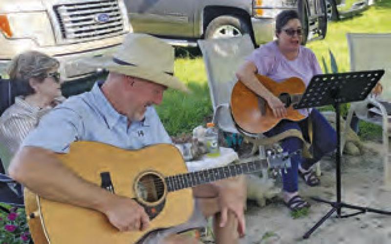 STEVE LOCKE AND Stacy Crocker perform on Sunday, May 19, at the Song Circle outside Front Street Burgers in Chriesman. Musicians and visitors are welcome at the gatherings, usually every other weekend.