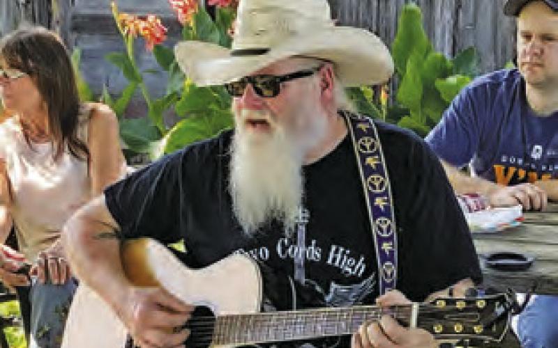 BILLY GAGE performs at the Song Circle outside Front Street Burgers in downtown Chriesman. The gatherings are enjoyed by area musicians and visitors.