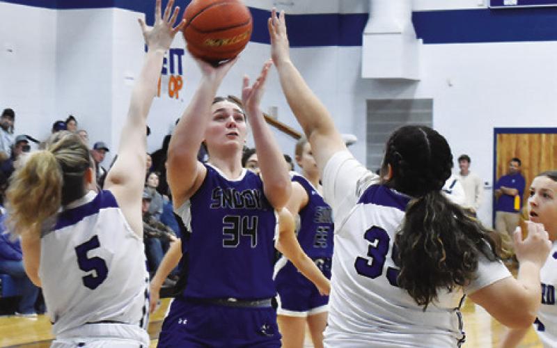 SNOOK’S ALEXIS MACIK is double-teamed by Mumford’s Senovia Tisdale and Olivia Rodriguez during the Snook-Mumford game on Friday in Mumford. -- Tribune photo by Roy Sanders