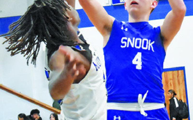 JUSTIN HRUSKA takes a shot against Mumford. -- Tribune photo by Roy Sanders