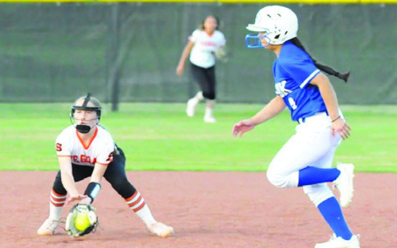 SOMERVILLE SHORTSTOP AUBREY Flencher fields a ground ball while Snook’s Ashley Quevedo runs from second to third.