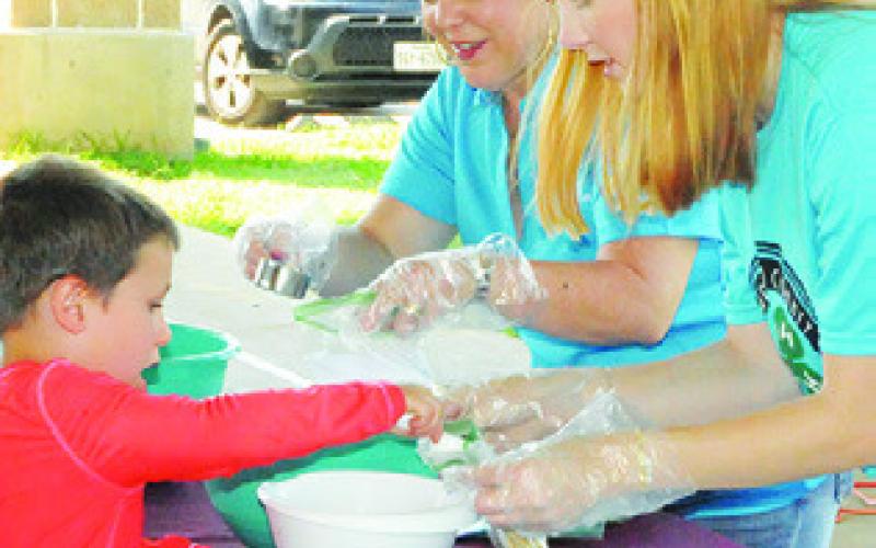 MAKING YOUR OWN trail mix was one of the activities area children enjoyed during last Thursday’s Harrie P. Woodson Memorial Library event. Assisting the children with this project were Holly Narro, Texas A&amp;amp;M AgriLife County Extension Agent, and Gracey Leopold, Texas A&amp;amp;M Summer Intern. -- Tribune photo by Denise Squier CHILDREN ARE patiently waiting for water