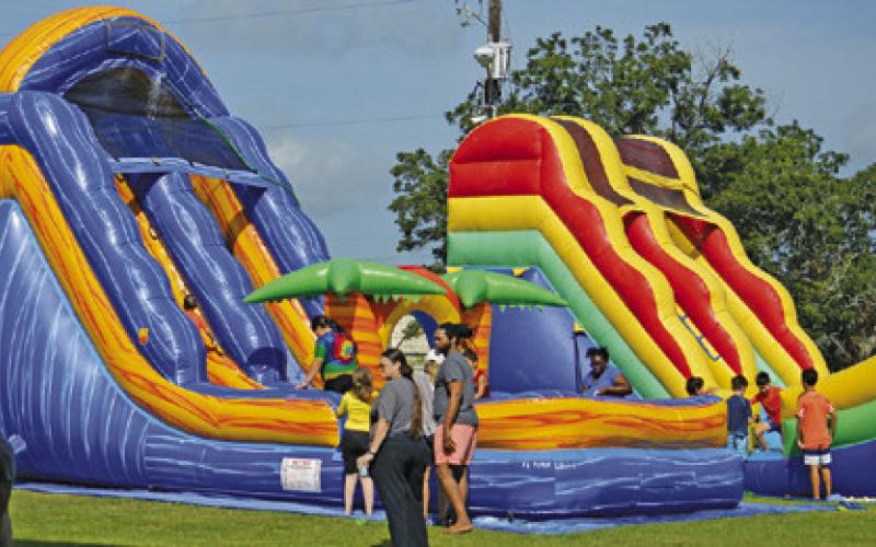 AREA CHILDREN ENJOYED WATERSLIDES and other fun activities at the Harrie P. Woodson Memorial Library’s end of summer water party at J.E. Hejl Park at Davidson Creek. Tribune photo by Kimberly Hutcheson