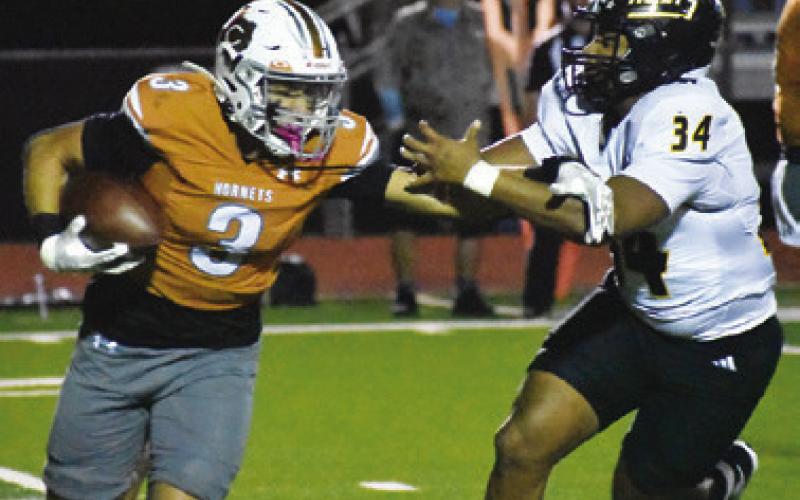 COY BECKA OF Caldwell breaks away from this Sealy defender. Tribune photo by Roy Sanders