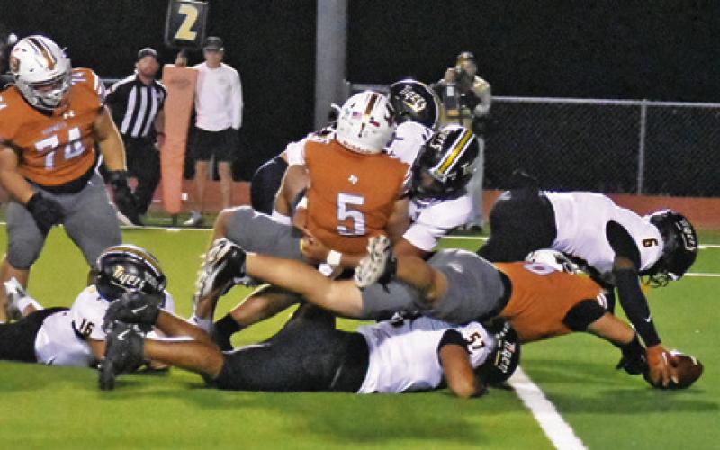 JOHN FRYREAR IS tackled as a Sealy player reaches for the ball. Tribune photo by Roy Sanders
